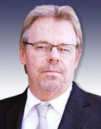 Dan Zanger Wearing a Black Suit with a Silver Tie